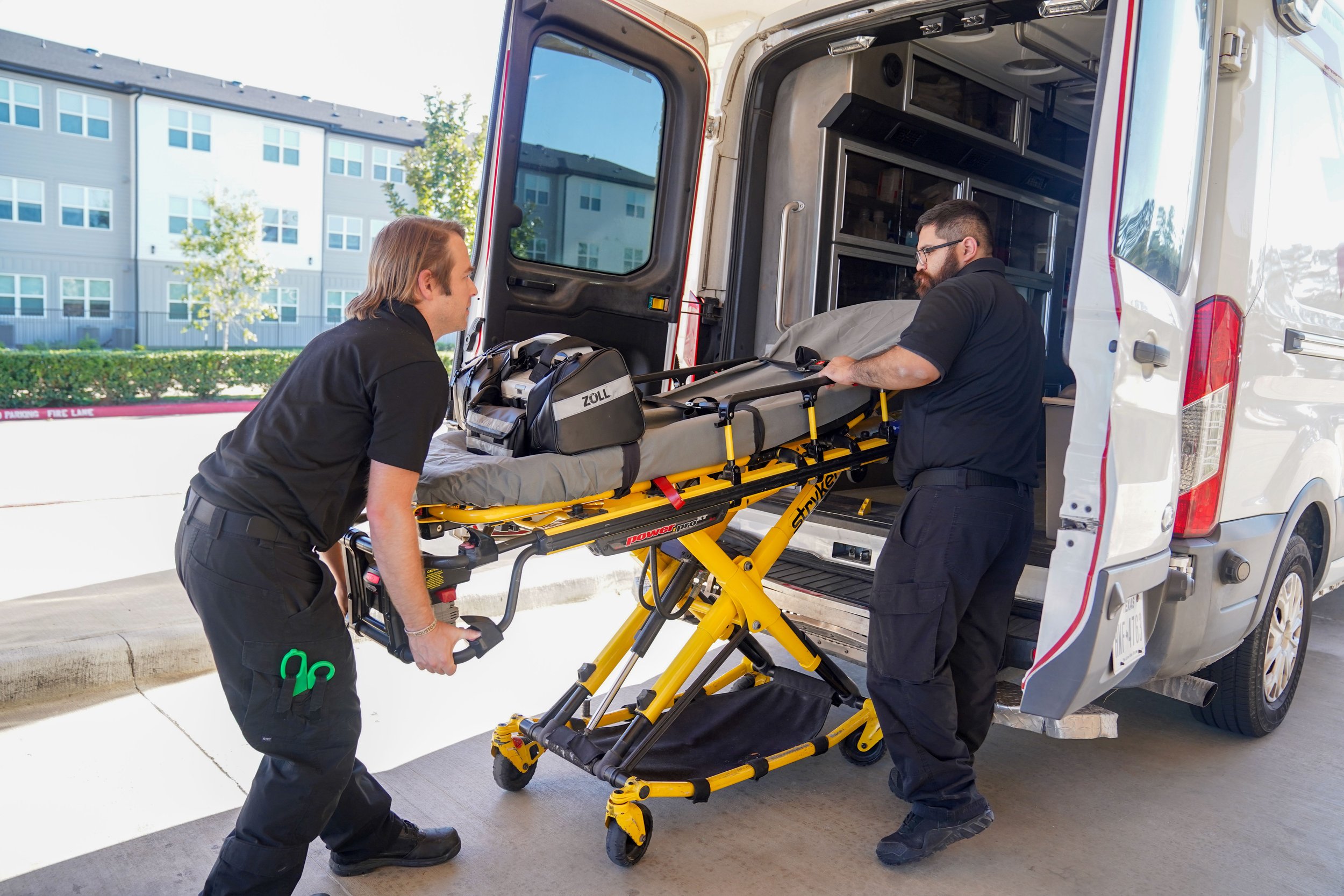 North Cypress Employees loading a stretcher into an ambulance with